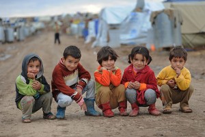 Syrian children sit on the ground in Domiz refugee camp, northern Iraq